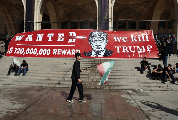 epa13088373 Iranians hold an anti Trump banner as they take part in a mass prayer for late Iranian supreme leader Ayatollah Ali Khamenei during a farewell ceremony ahead of his funeral at the grand Mo ...