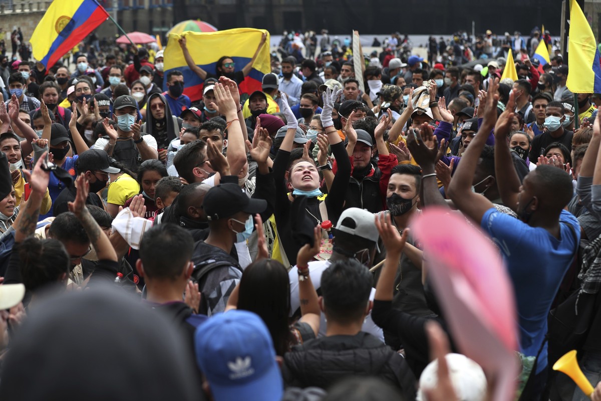 People shout slogans during a demonstration against government-proposed tax reform, marking May Day, or International Workers' Day, gathered in Bolivar Square in Bogota, Colombia, Saturday, May 1 ...