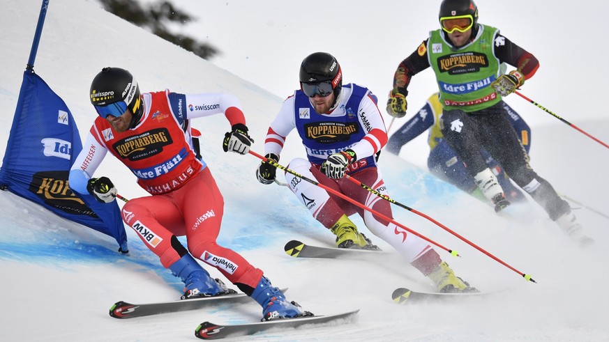 epa09009418 Alex Fiva (L) of Switzerland and Johannes Aujesky (C) of Austria in action during the heats at the FIS Ski Cross World Championships 2021 in Idre, Sweden, 13 February 2021. EPA/ANDERS WIKL ...