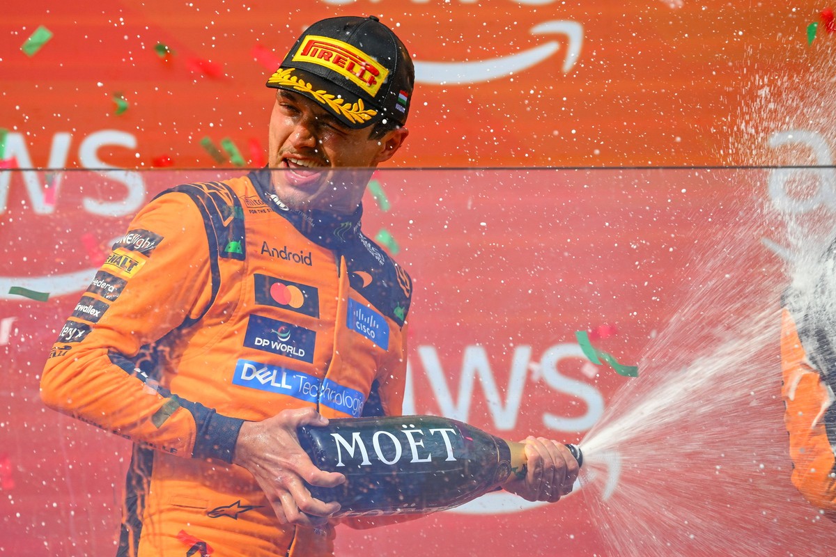 epa13134208 Winner McLaren driver Lando Norris of Britain celebrates on the podium after the Formula One Hungarian Grand Prix at the Hungaroring circuit in Mogyorod, Hungary, 26 July 2026. EPA/Zsolt C ...