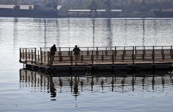 epa12849155 A person fishes at the seafront promenade in Havana, Cuba, 25 March 2026. The Caribbean nation has been experiencing a severe crisis since mid-2014, which has deepened with the oil embargo ...