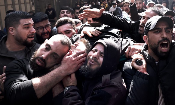 epa10483402 Palestinians carry the body of a man killed amid an Israeli operation in the west bank city of Nablus, 22 February 2023. According to the Palestinian Health Ministry at least six Palestini ...