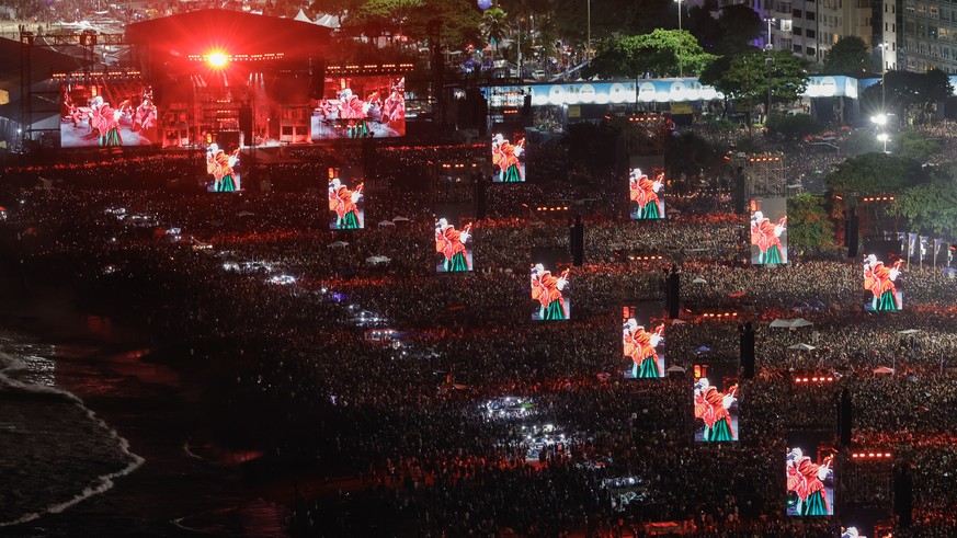 epaselect epa12072308 Displays show American singer and songwriter Lady Gaga performing during a free mega concert at Copacabana beach in Rio de Janeiro, Brazil, 03 May 2025. EPA/ANDRE COELHO