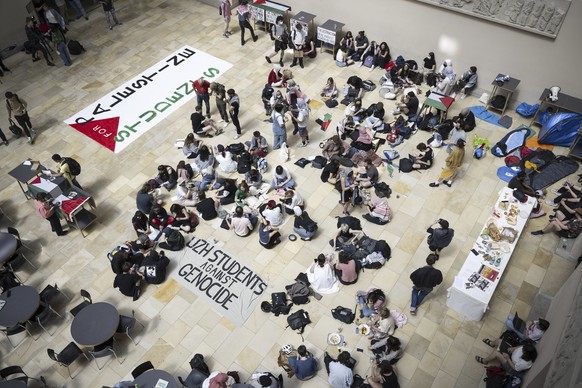Pro-Palestinian demonstrators stage a protest in the entrance hall of the main building at the University of Zurich (UZH), in Zurich, Switzerland on Tuesday, May 14, 2024. (Ennio Leanza/Keystone via A ...