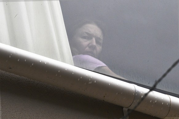 A person believed to be Renata Voracova, a tennis player from the Czech Republic, looks out of a window at the Park hotel immigration detention centre in Melbourne, Australia, Saturday, Jan. 8, 2022.  ...