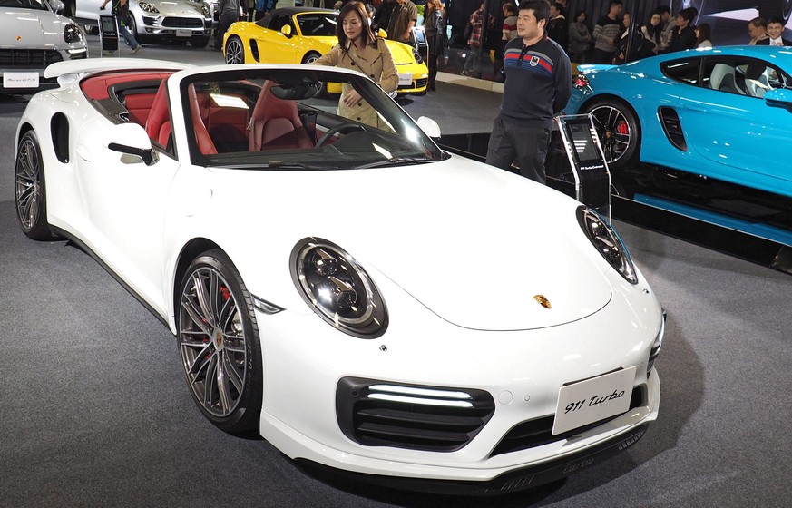 epa05686892 Visitors inspect a Porsche 911 Turbo car during the 2017 Taipei Auto Show held at the Taipei World Trade Center in Taipei, Taiwan, 23 December 2016. The show displays mostly foreign cars,  ...