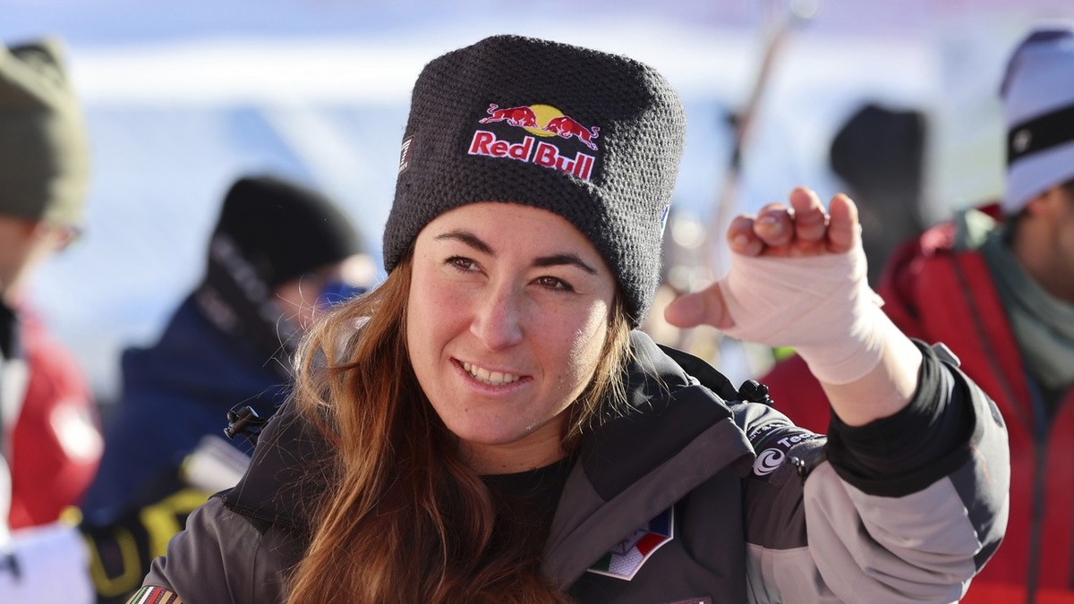 Italy's Sofia Goggia salutes in the finish area after crossing the finish line to win an alpine ski, women's World Cup downhill race, in St. Moritz, Switzerland, Saturday, Dec. 17, 2022. (AP ...