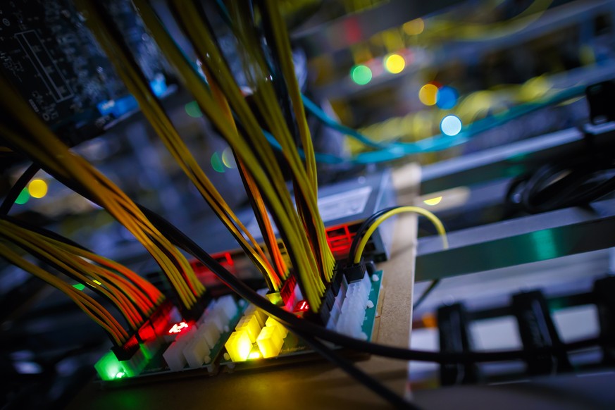 LED lights are pictured on an electronic board in a cryptocurrency mine in the small alpine village of Gondo, Switzerland, Monday, May 7, 2018. The village formerly host to gold mining activities over ...