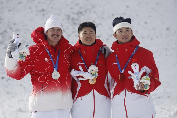 epa12761790 Silver medalist Noe Roth from Switzerland , gold medalist Xindi Wang from China and bronze medalist Tianma Li from China react in the podium after the Men's Aerials finals of the Free ...