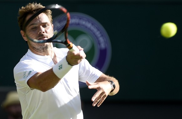 epa06063936 Stan Wawrinka of Switzerland in action against Daniil Medvedev of Russia during their first round match for the Wimbledon Championships at the All England Lawn Tennis Club, in London, Brit ...