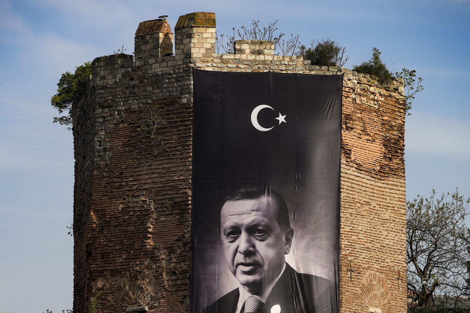 A giant banner of Turkish President and People&#039;s Alliance&#039;s presidential candidate Recep Tayyip Erdogan is displayed on an historical city wall, in Istanbul, Turkey, Saturday, April 22, 2023 ...