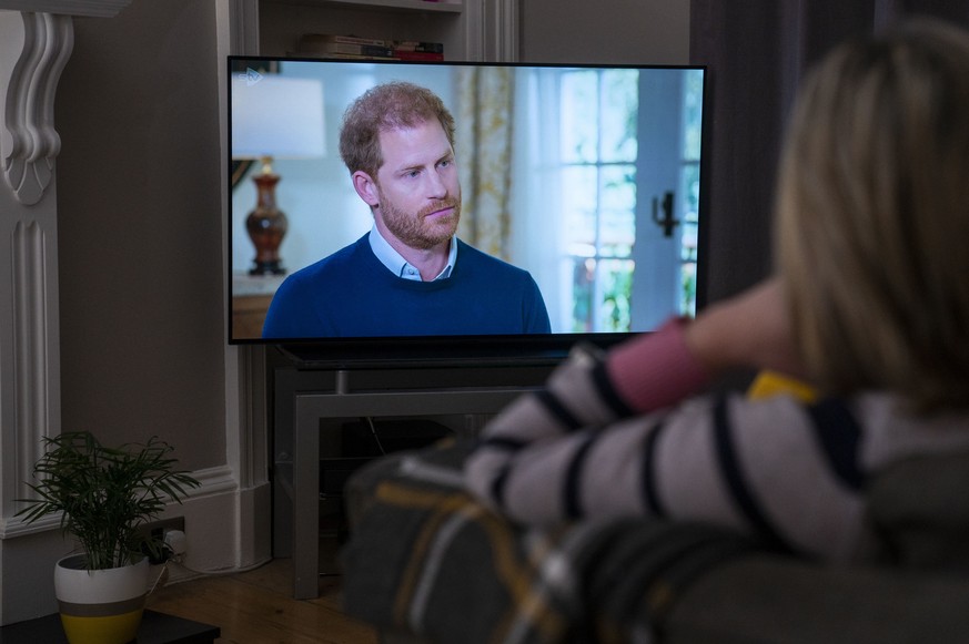 A person at home in Edinburgh watches Prince Harry, the Duke of Sussex, being interviewed by ITV&#039;s Tom Bradby during &quot;Harry: The Interview,&quot; two days before his controversial autobiogra ...
