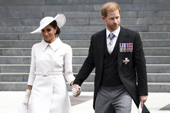 Prince Harry and Meghan, Duchess of Sussex hold hands as they depart after attending a service of thanksgiving for the reign of Queen Elizabeth II at St Paul���s Cathedral in London Friday June 3, 202 ...