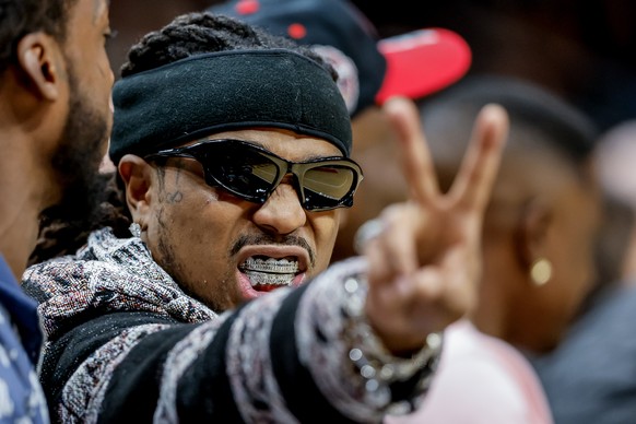 epa10953676 US rapper Quavo, (Quavious Keyate Marshall) reacts while watching game action during the second half of the NBA basketball game between the Washington Wizards and the Atlanta Hawks at Stat ...