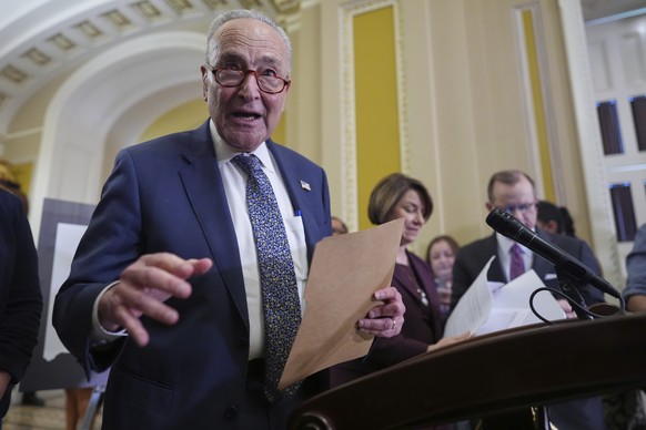 Senate Minority Leader Chuck Schumer, D-N.Y., joined by Sen. Amy Klobuchar, D-Minn., right, speak to reporters following closed-door party meetings at the Capitol in Washington, Tuesday, June 17, 2025 ...