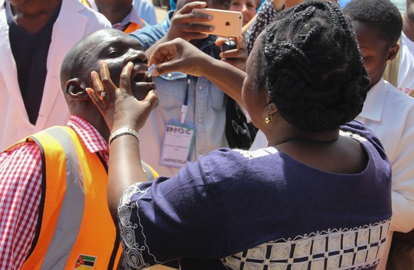 epa07482831 A local man receives a Cholera vaccine, in Beira, Mozambique, 03 April 2019. A vaccination campaign against a cholera outbreak started in the center of Mozambique and should cover a popula ...