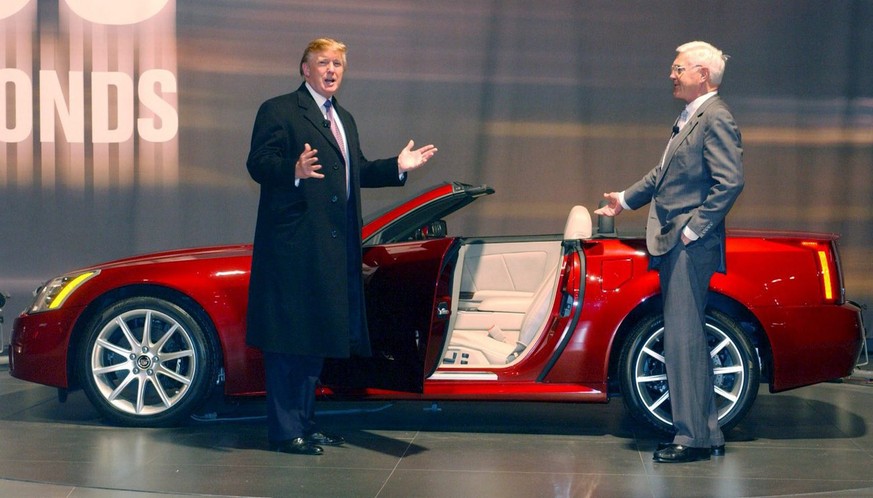 A photograph showing New York icon Donald Trump (L) helping General Motors Vice Chairman Bob Lutz introduce the new 2006 Cadillac XLR-V in &#039;under 5 seconds&#039; at the New York International Aut ...