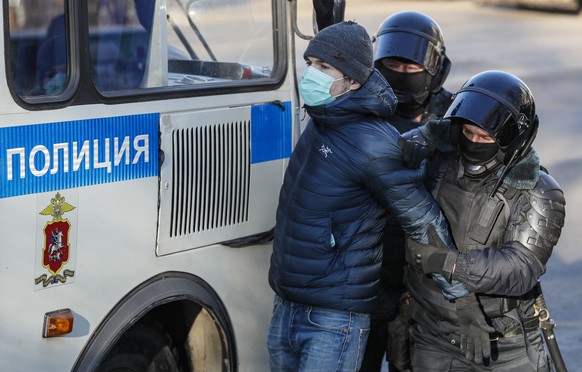 epa08980924 Russian policemen detain a Navalny supporter near the Moscow City Court building in Moscow, Russia, 02 February 2021. The Moscow City Court will consider on 02 February 2021 the requiremen ...