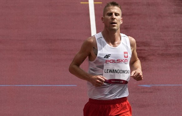 Marcin Lewandowski, of Poland crosses the line at the back of the field after falling in a men&#039;s 1,500-meter heat at the 2020 Summer Olympics, Tuesday, Aug. 3, 2021, in Tokyo, Japan. (AP Photo/Ch ...