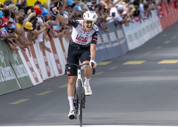 epa12069537 Jay Vine from Australia of UAE Team Emirates XRG celebrates crossing the finish line to win the third stage of the Tour de Romandie cycling tour over 183.1km from Cossonay to Cossonay, Swi ...