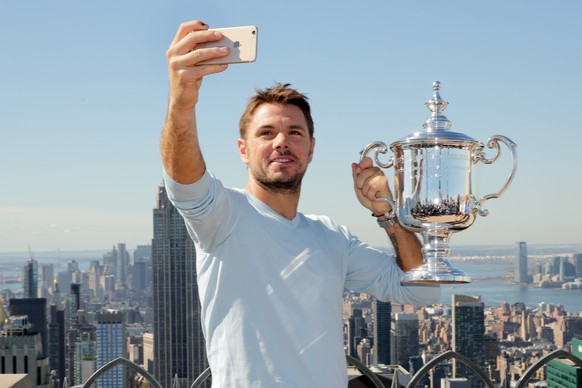 U.S. Open men's singles tennis champion Stan Wawrinka takes a selfie picture as he poses for photos at the "Top of the Rock," in New York's Rockefeller Center, Monday, Sept. 12, 20 ...