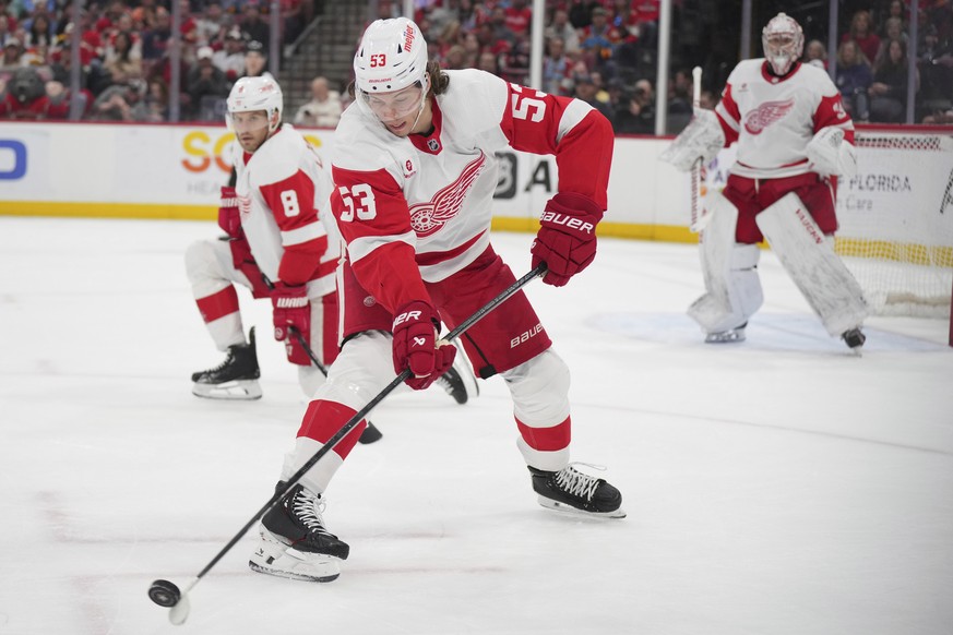 Detroit Red Wings defenseman Moritz Seider (53) looks to clear the zone against the Florida Panthers during the first period of an NHL hockey game Saturday, March 30, 2024, in Sunrise, Fla. (AP Photo/ ...