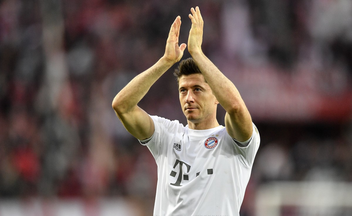 Bayern's Robert Lewandowski celebrates with supporters after winning the German Bundesliga soccer match between 1. FC Cologne and Bayern Munich in Cologne, Germany, Sunday, Feb. 16, 2020. (AP Pho ...