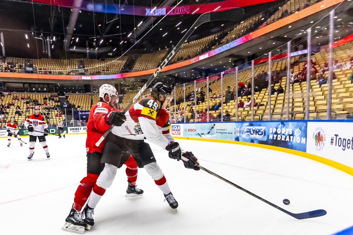 Switzerland's forward Damien Riat, left, vies for the puck with Austria's defender Gregor Biber, right, during the IIHF 2025 World Championship quarter final game between Switzerland and Aus ...