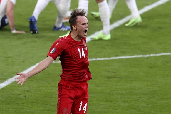 Denmark&#039;s Mikkel Damsgaard, center, celebrates after scoring the opening goal during the Euro 2020 soccer championship semifinal match between England and Denmark at Wembley stadium in London, We ...