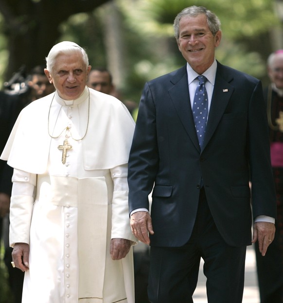 FILE - President Bush walks with Pope Benedict XVI to the Lourdes Grotto at the Vatican on June 13, 2008. Pope Emeritus Benedict XVI, the German theologian who will be remembered as the first pope in  ...