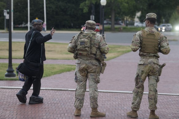 Armed members of the South Carolina National Guard talk with a man while positioned outside of Union Station in Washington, Sunday, Aug. 24, 2025. (AP Photo/Rod Lamkey, Jr.)
Trump District of Columbia