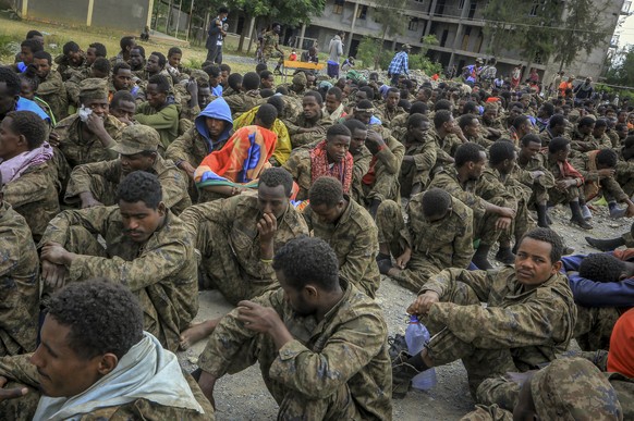 Captured Ethiopian government soldiers and allied militia members sit in rows after being paraded by Tigray forces through the streets in open-top trucks, as they arrived to be taken to a detention ce ...