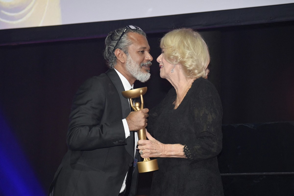 Britain's Camilla, Queen Consort, presents winner Shehan Karunatilaka with the trophee for "The Seven Moons of Maali Almeida" during the Booker Prize at the Roundhouse in London, Monday ...