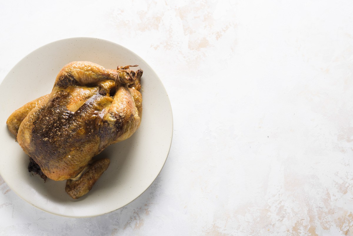 This image released by Milk Street shows a recipe for Garam Masala + Tamarind Roasted Chicken. (Milk Street via AP)