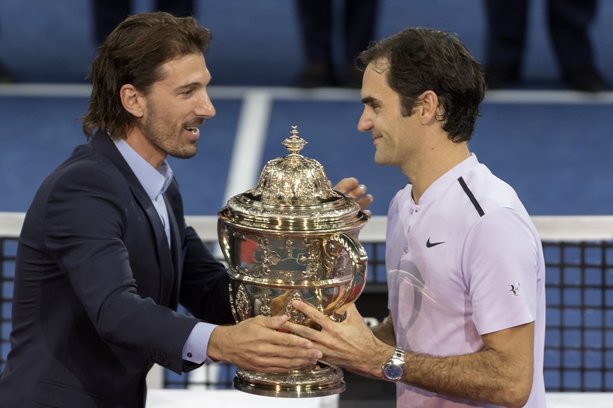 Fabiian Cancellara, left, and Roger Federer, right, during the award ceremony after the final between Switzerland&#039;s Roger Federer and Argentina&#039;s Juan Martin del Potro at the Swiss Indoors t ...