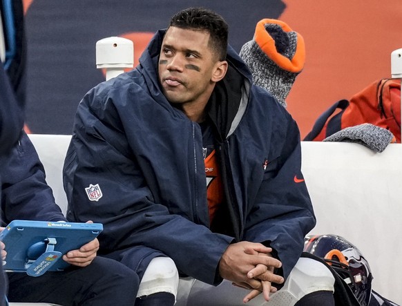 FILE - Denver Broncos quarterback Russell Wilson sits on the bench during the second half of an NFL football game against the Los Angeles Chargers, Sunday, Dec. 31, 2023, in Denver. Wilson has agreed  ...