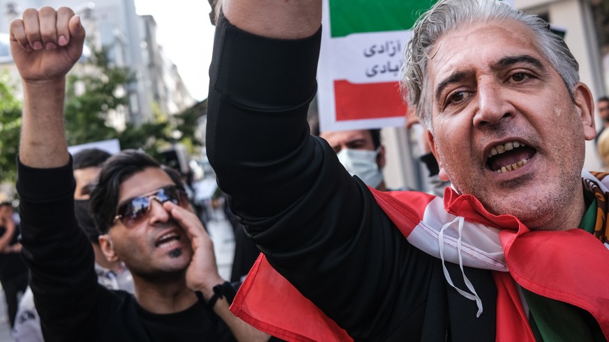 epa10236126 Iranian people hold pictures of Mahsa Amini with their hands painted in red during a protest outside the Iranian Consulate following the death of Mahsa Amini, in Istanbul, Turkey, 11 Octob ...