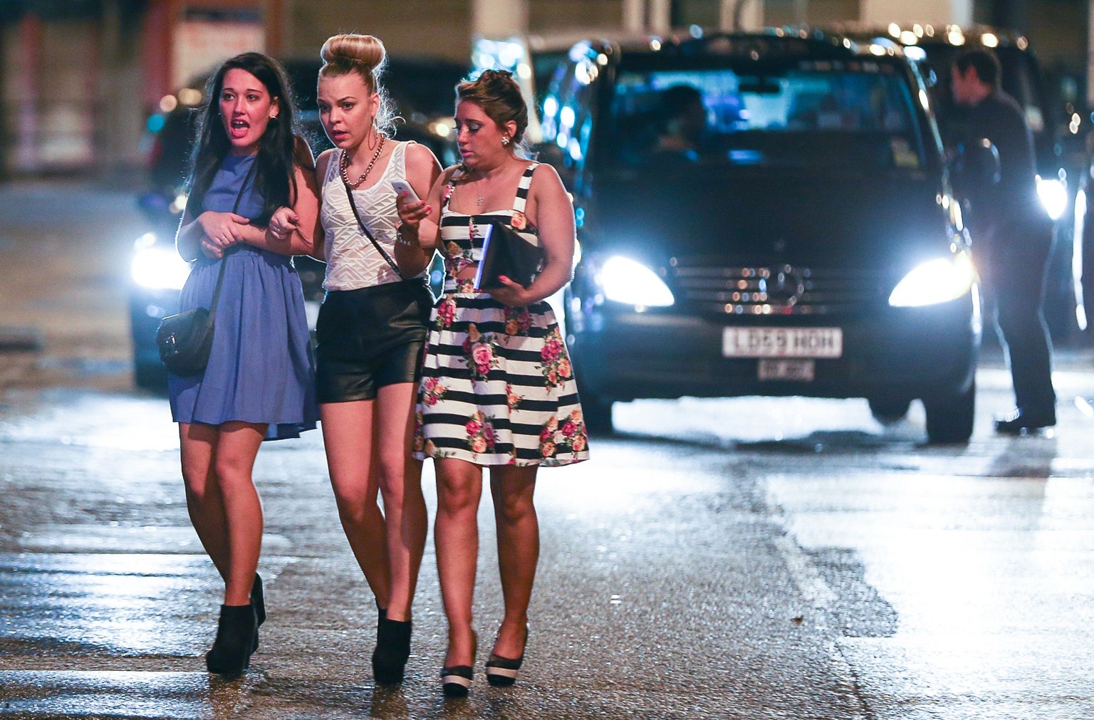 Mandatory Credit: Photo by London News Pictures/REX/Shutterstock (3466396f)
Three women cross the street towards the Printworks nightclub venue
New Year's celebrations, Manchester, Britain - 31 Dec  ...
