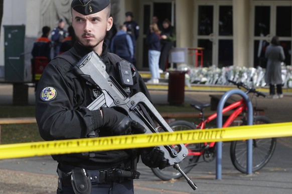 A police officer guards the entrance to Gambetta high school, Monday, October 8.  January 16, 2023 in Arras, Northern France.  French authorities say the high school where a teacher was fatally stabbed in an attack...