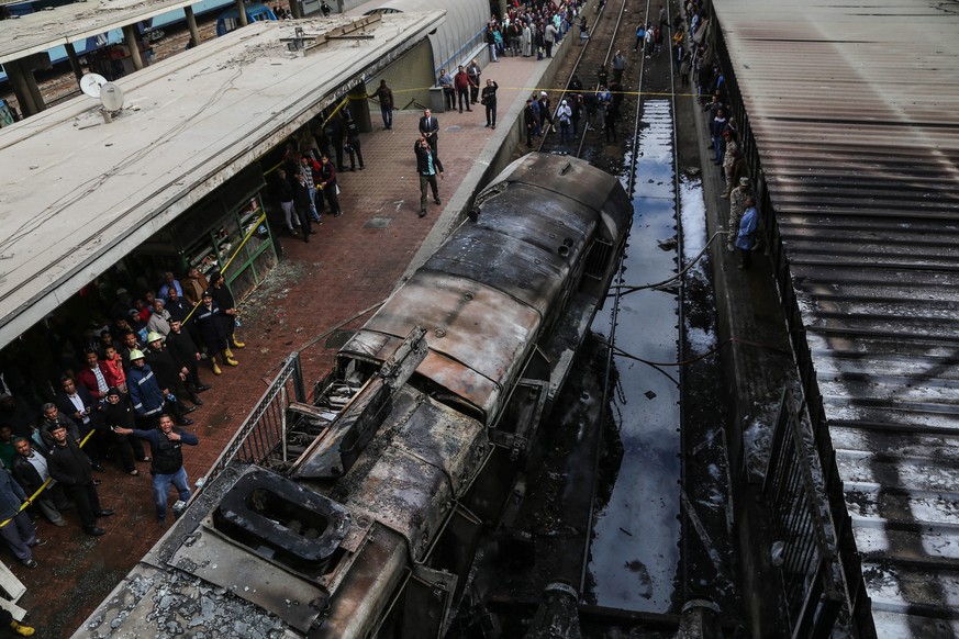 epa07400873 A burnt-out train engine rests on tracks at the main train station in Cairo, Egypt, 27 February 2019. According to reports, at least 20 people were killed and another 40 were injured when  ...