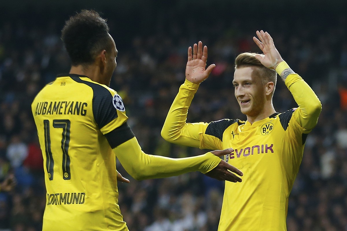 Dortmund's Marco Reus, right, celebrates with Pierre-Emerick Aubameyang after scoring his side's 2nd goal during the Champions League, Group F, soccer match between Real Madrid and Borrusia  ...