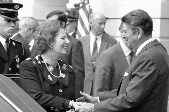 FILE- In this file photo dated Sept. 29, 1983, US President Ronald Reagan shakes hands with British Prime Minister Margaret Thatcher after their meeting, at the White House in Washington. In a secret  ...