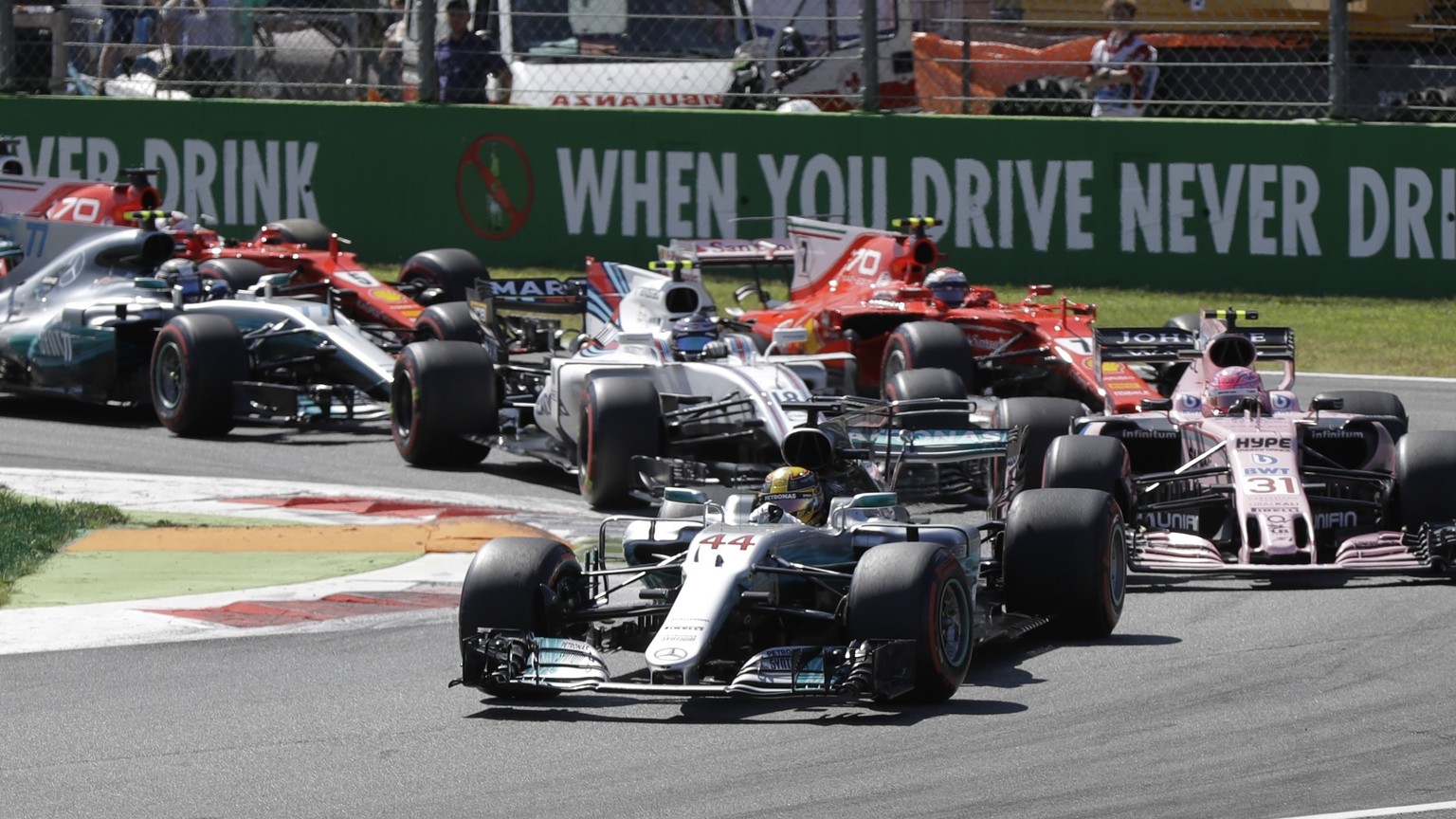 Mercedes driver Lewis Hamilton of Britain leads Force India driver Esteban Ocon of France and the rest of the pack, during the first laps of the Italian Formula One Grand Prix, at the Monza racetrack, ...