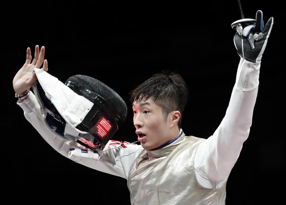 epa09367681 Cheung Ka Long Hong Kongcelebrates after his victory over Daniele Garozzo Italy in the Men&#039;s foil Individual Golden medal bout during the Fencing events of the Tokyo 2020 Olympic Game ...