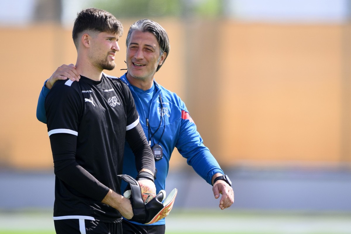 Switzerland's head coach Murat Yakin, right, speaks with Switzerland's goalkeeper Gregor Kobel, left, during a open training session of Swiss national soccer team in preparation for the FIFA ...