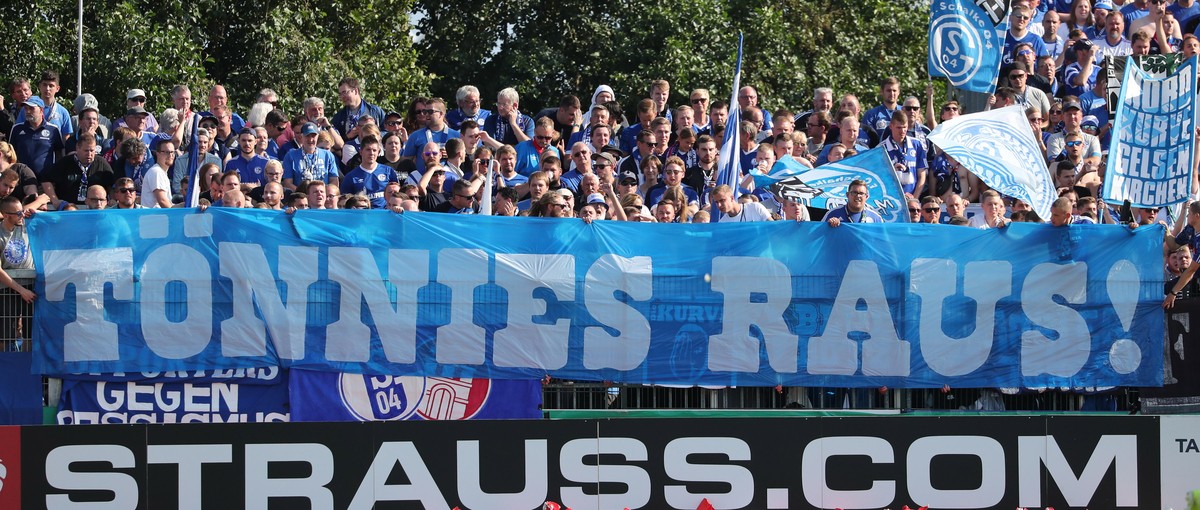epa07766367 Schalke's supporters hold a banner reading 'Toennies out!' to demonstrate against the chairman of Schalke's supervisory board, Clemens Toennies, during the German DFB C ...