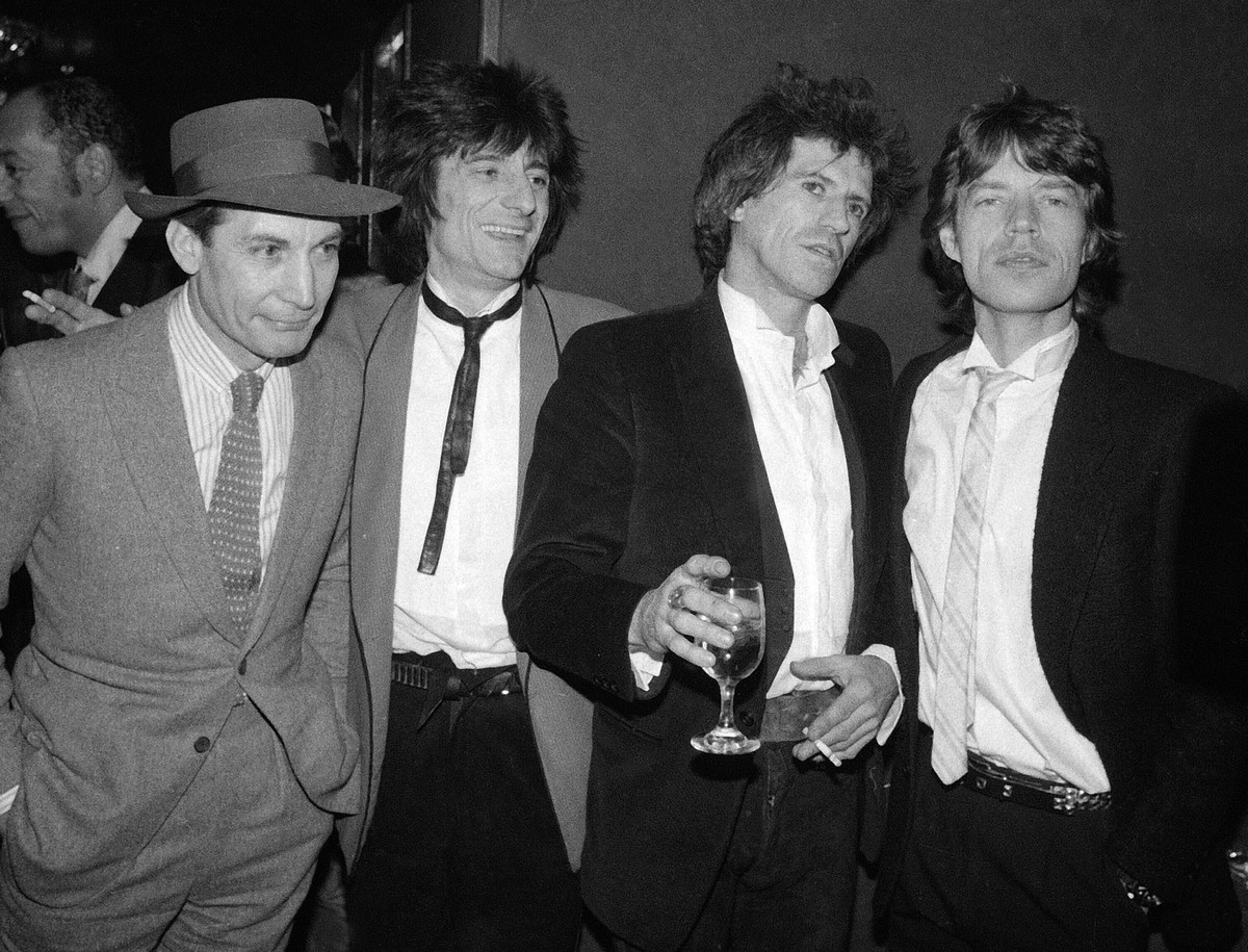 FILE - Members of the Rolling Stones, from left, Charlie Watts, Ron Wood, Keith Richards, and Mick Jagger appear at a party celebrating the opening of their film "Let's Spend The Night Toget ...
