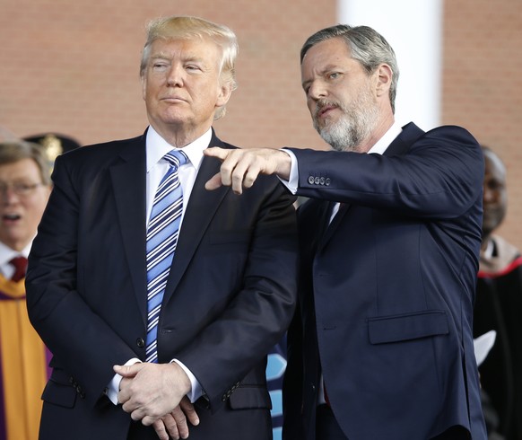 In this photo taken May 13, 2017, President Donald Trump stands with Liberty University President Jerry Falwell Jr. in Lynchburg, Va. Falwell, and an early backer of Trump, said the president had made ...