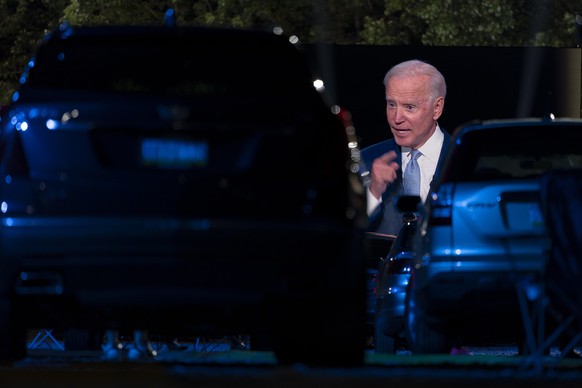 Audience members watch from their cars as Democratic presidential candidate former Vice President Joe Biden, seen on a monitor, speaks during a CNN town hall in Moosic, Pa., Thursday, Sept. 17, 2020.  ...
