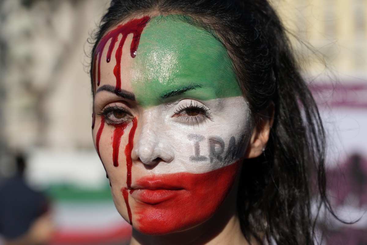 A woman is painted on a her face during a protest against the death of Mahsa Amini, a woman who died while in police custody in Iran, during a rally in central Rome, Saturday, Oct. 29, 2022. (AP Photo ...